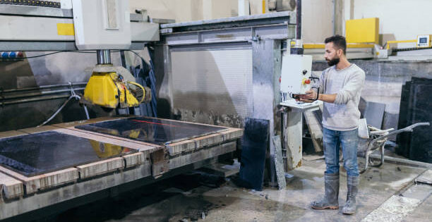 Stonebax-Marble worker with electric saw.